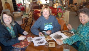 Alice's granddaughters Marilyn and Chris  enjoying old family photos with Barb. 